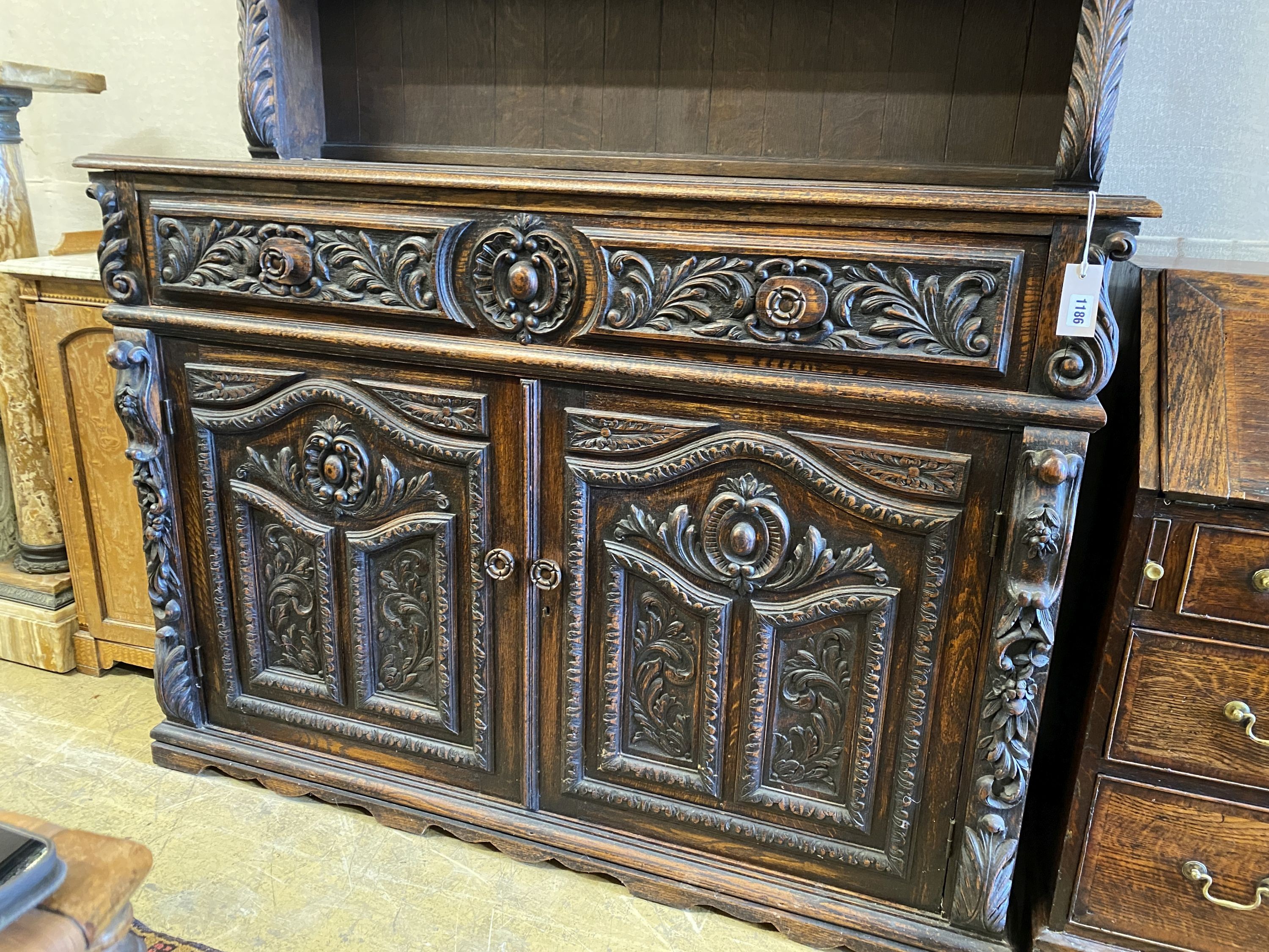 A late 19th century Flemish carved oak dresser, length 135cm, depth 50cm, height 192cm